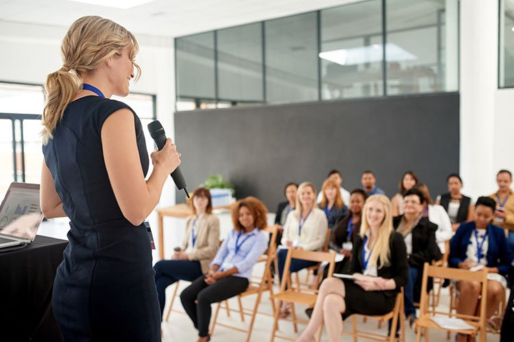 Woman presenting to group of people