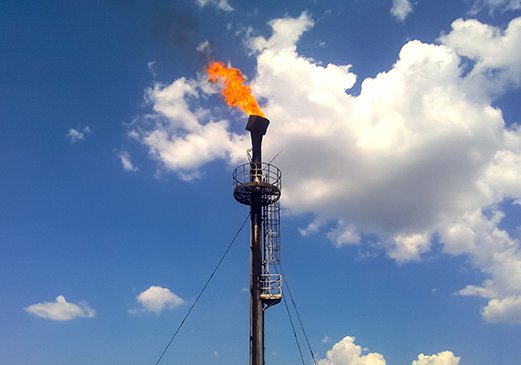 Associated gas flare on an oil lease