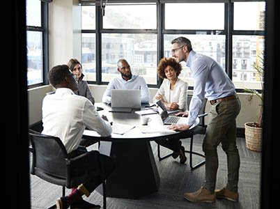 Man speaking to others around a table